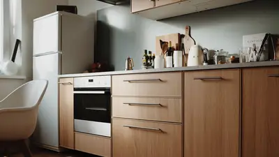 Beautiful modern kitchen featuring sleek wooden cabinets and appliances.
