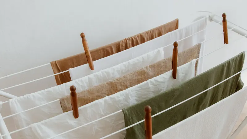 A minimalist image of clothes drying on a rack indoors, showcasing neatness and order.