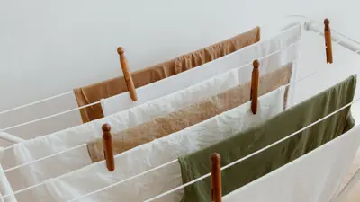 A minimalist image of clothes drying on a rack indoors, showcasing neatness and order.
