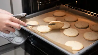 Close-up of cookies on a tray being baked in a kitchen oven.
