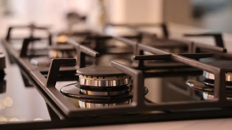 Close-up of a modern stainless steel gas stove top, ideal for contemporary kitchens and cooking environments.