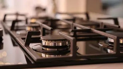 Close-up of a modern stainless steel gas stove top, ideal for contemporary kitchens and cooking environments.