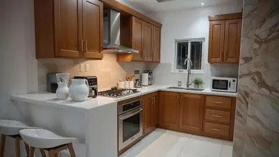 A clean and modern kitchen featuring wooden cabinets and stainless steel appliances.