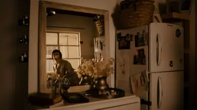 Warm indoor scene capturing a reflection in a mirror with home decor.