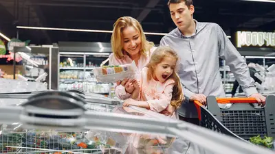 Happy family spending time together shopping at a grocery store.